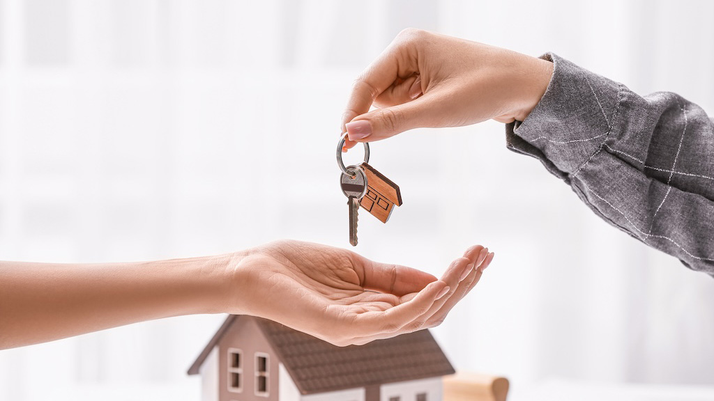 Real estate agent giving a key