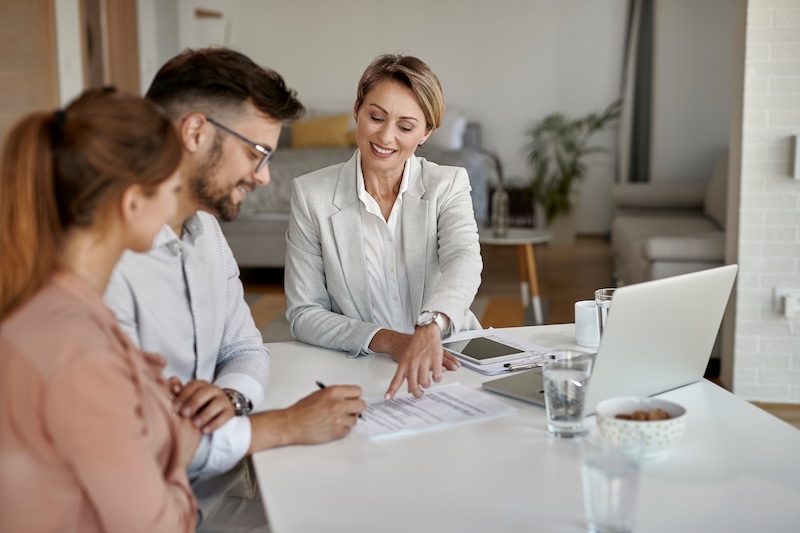 Real estate agent with couple contract signing